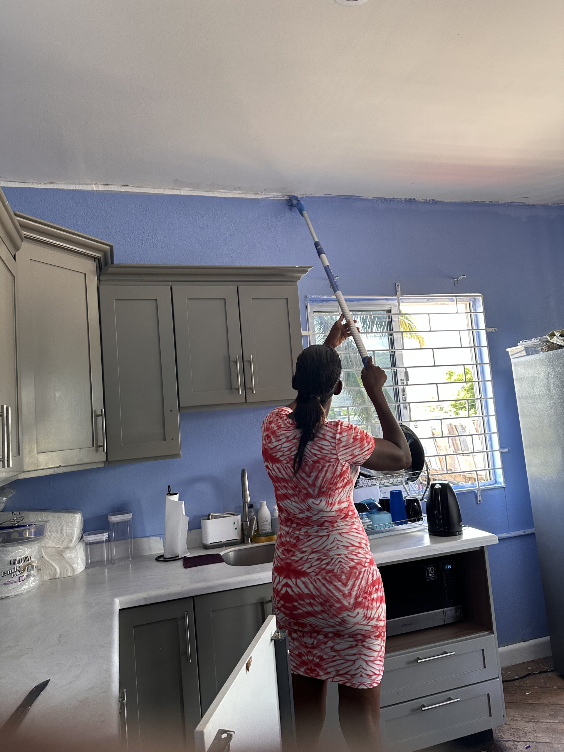 Woman painting kitchen