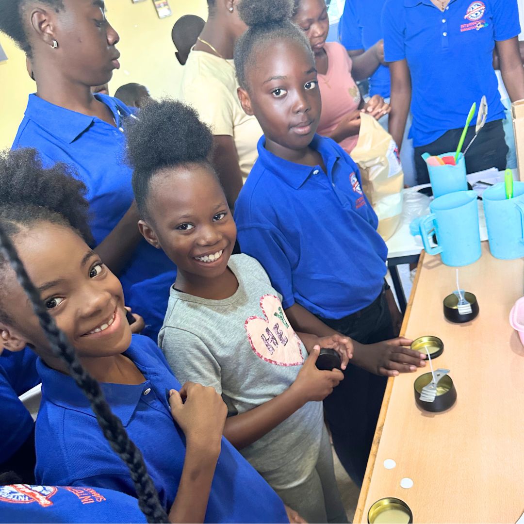 Scholarship students in Jamaica making candles in a workshop.